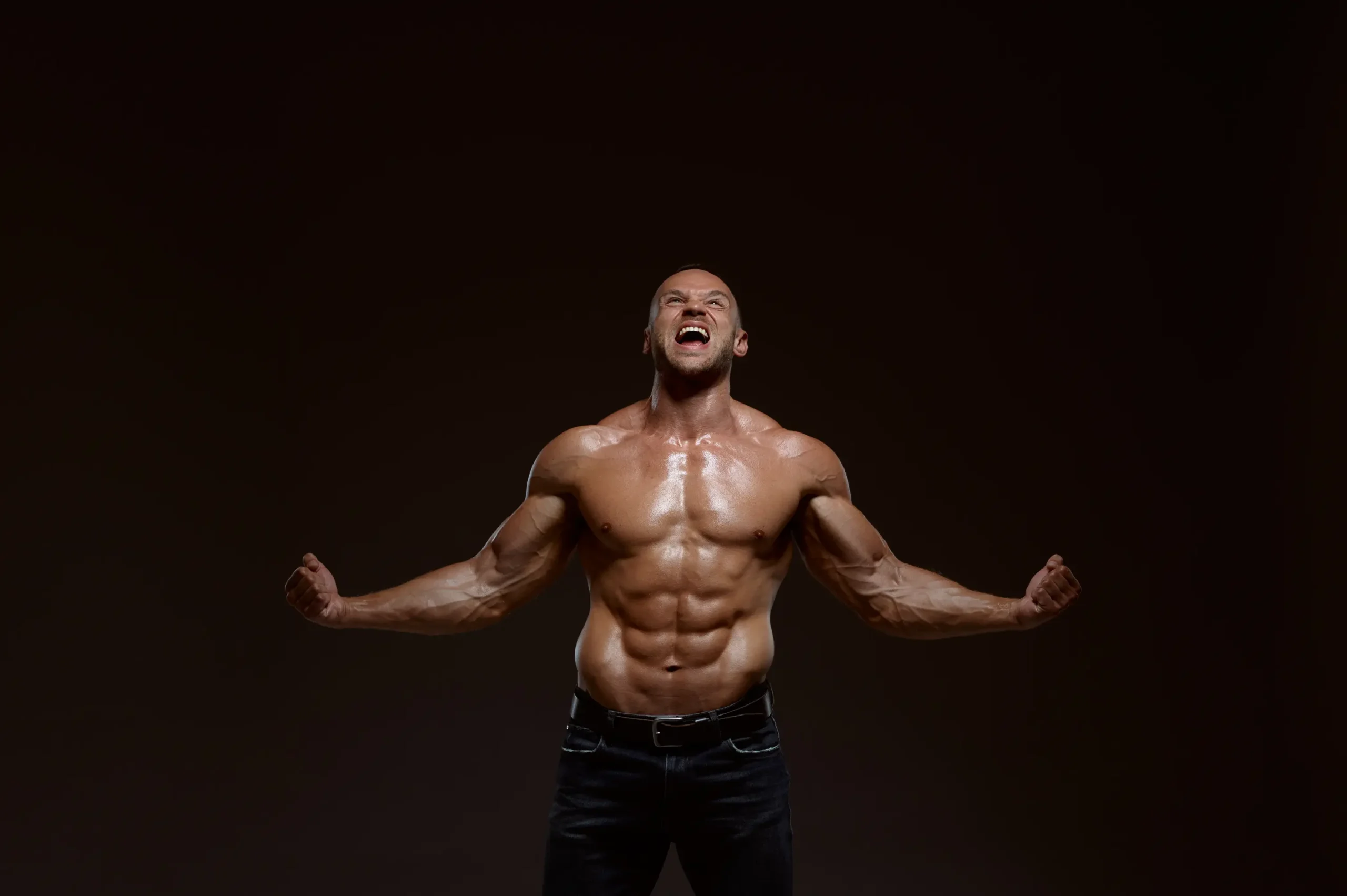 male muscular athlete shows his power in studio 2024 12 04 10 18 48 utc scaled